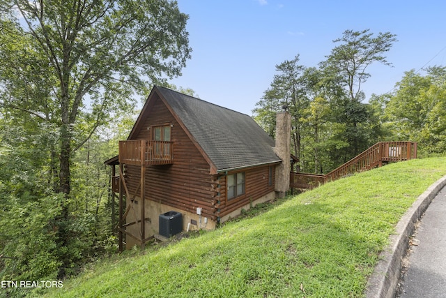 view of property exterior featuring a yard and central AC unit