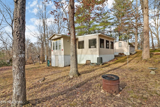 view of side of home featuring central AC and a sunroom