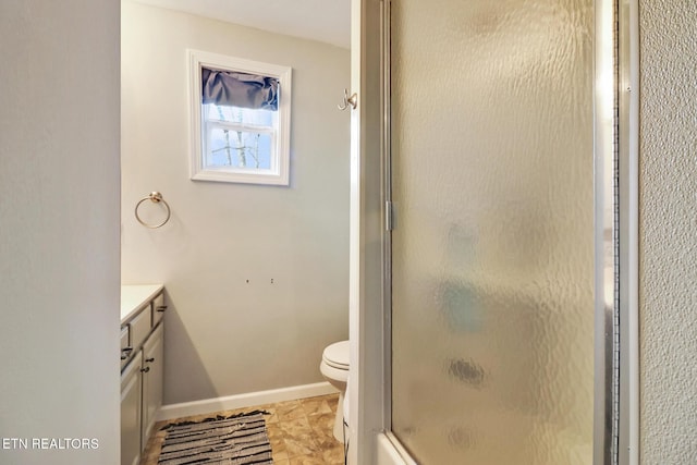 bathroom with vanity, toilet, and an enclosed shower