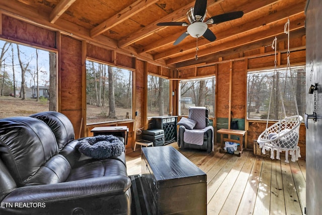 sunroom with beam ceiling, wood ceiling, and ceiling fan