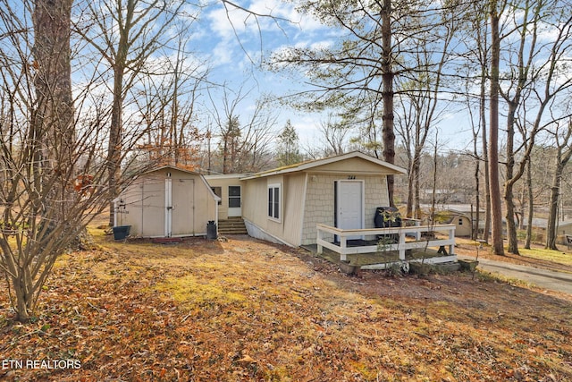 view of home's exterior with a storage unit