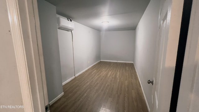 spare room featuring dark hardwood / wood-style flooring and a wall mounted AC