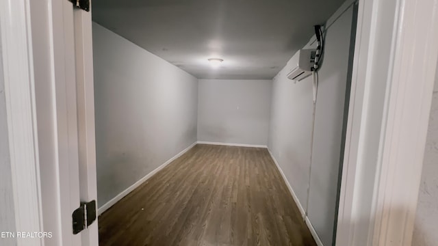 interior space featuring an AC wall unit and dark hardwood / wood-style floors