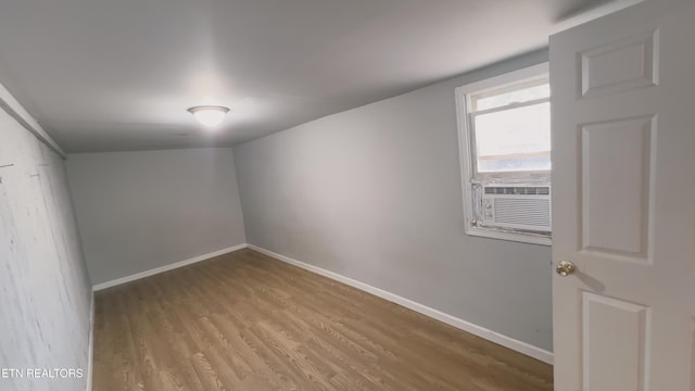 spare room with cooling unit and light hardwood / wood-style floors