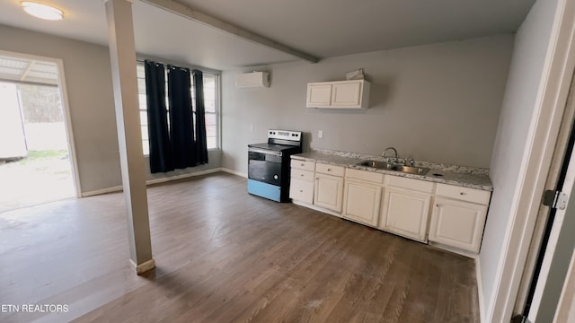 kitchen featuring sink, white cabinetry, a wall mounted AC, stainless steel electric range oven, and dark hardwood / wood-style flooring