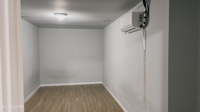 interior space with light hardwood / wood-style floors and an AC wall unit