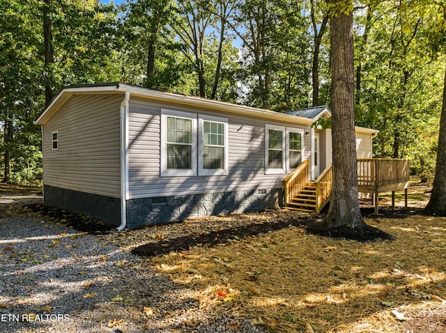 view of side of home with a deck