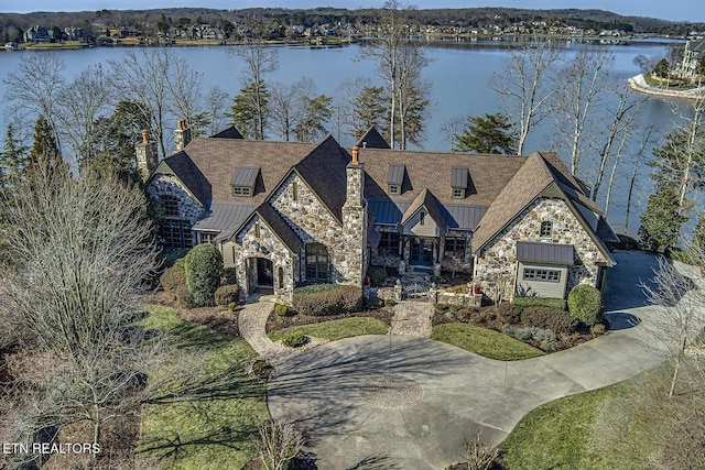 view of front of home with a garage and a water view