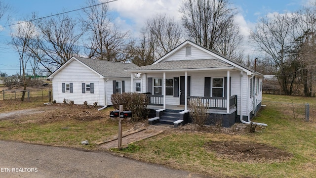 bungalow featuring a porch and a front yard