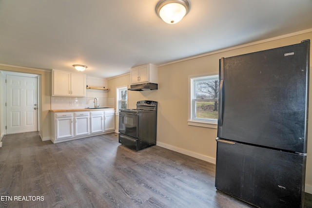 kitchen featuring sink, wood-type flooring, black appliances, and white cabinets