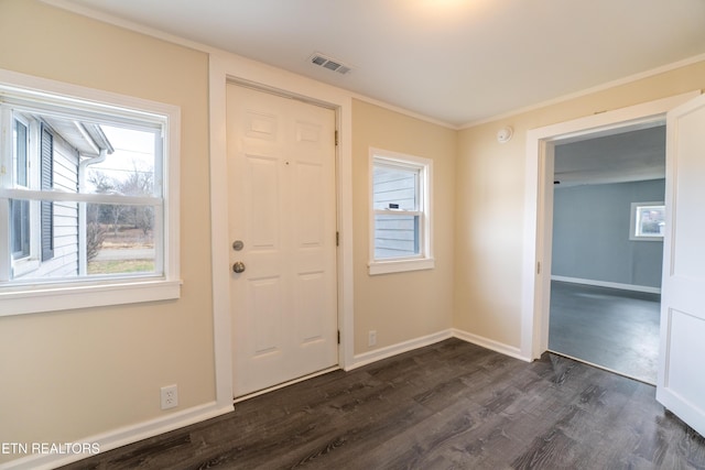 entrance foyer featuring crown molding and dark hardwood / wood-style flooring