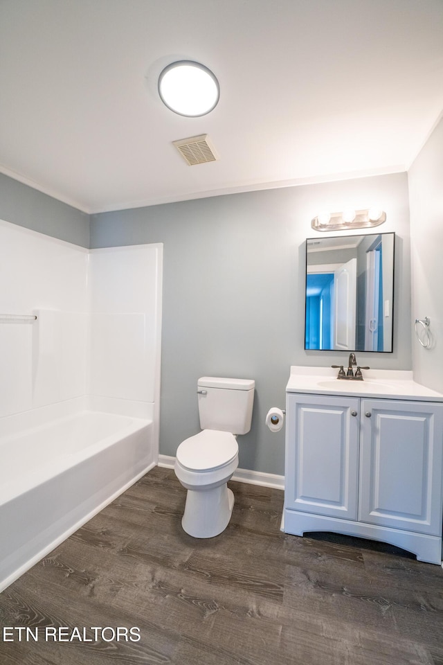 full bathroom with shower / bathtub combination, wood-type flooring, toilet, and vanity