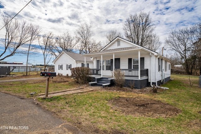 bungalow-style house with a front lawn and a porch