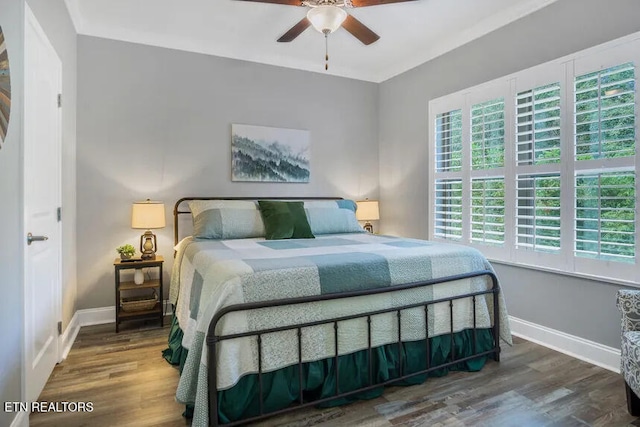 bedroom with dark hardwood / wood-style floors and ceiling fan