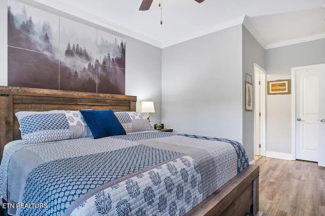 bedroom featuring ceiling fan, ornamental molding, and hardwood / wood-style floors