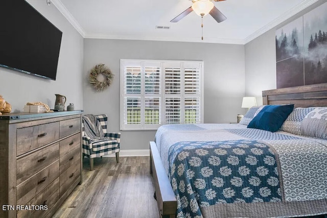 bedroom with crown molding, dark hardwood / wood-style floors, and ceiling fan