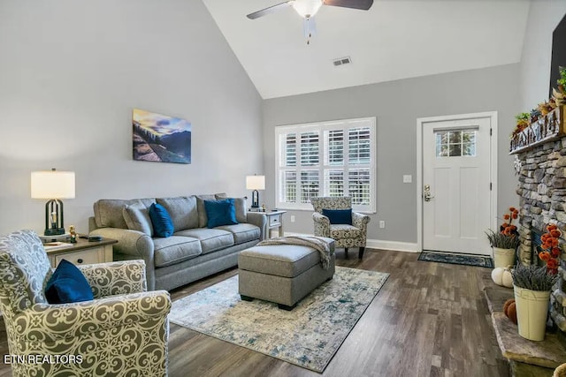 living room featuring ceiling fan, dark hardwood / wood-style floors, and high vaulted ceiling