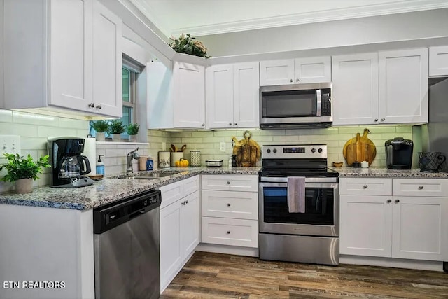 kitchen with white cabinetry, sink, dark hardwood / wood-style flooring, stainless steel appliances, and crown molding