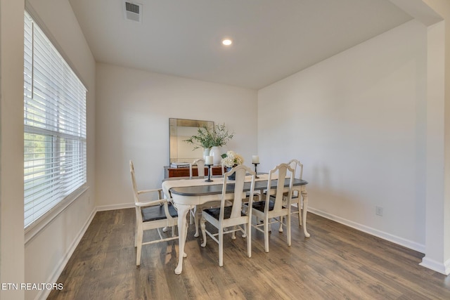 dining space with dark wood-type flooring