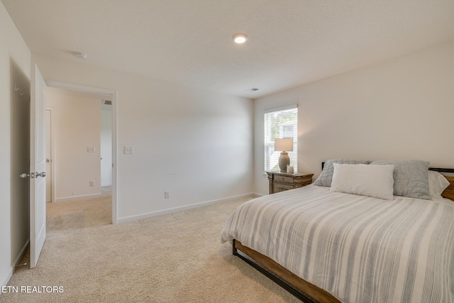 bedroom with light colored carpet