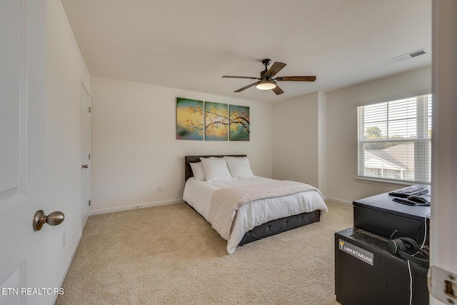 bedroom featuring light carpet and ceiling fan