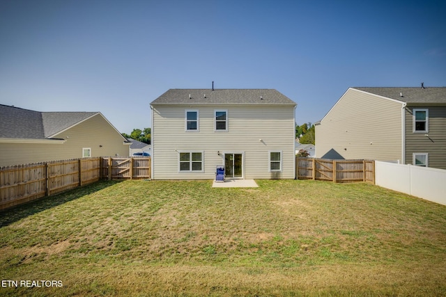 rear view of property with a yard and a patio