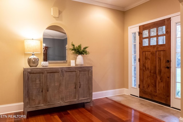 entrance foyer with wood-type flooring and crown molding