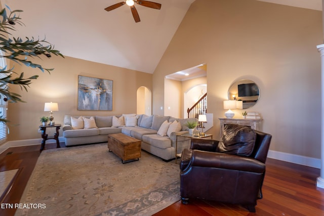 living room with ceiling fan, dark wood-type flooring, and high vaulted ceiling