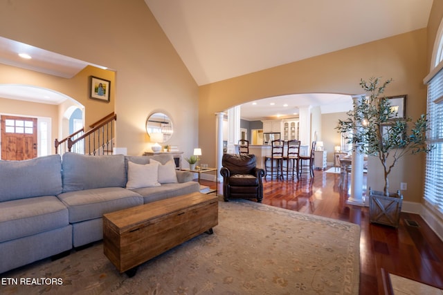 living room featuring dark hardwood / wood-style floors and high vaulted ceiling