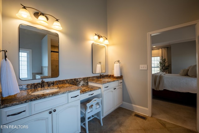 bathroom featuring tile patterned floors, vanity, and a wealth of natural light