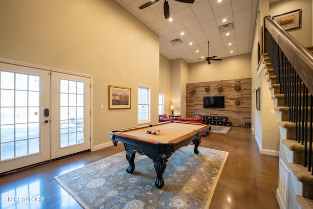 recreation room with ceiling fan, a towering ceiling, pool table, and french doors