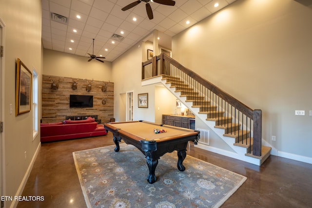 rec room with a towering ceiling, a paneled ceiling, pool table, and ceiling fan