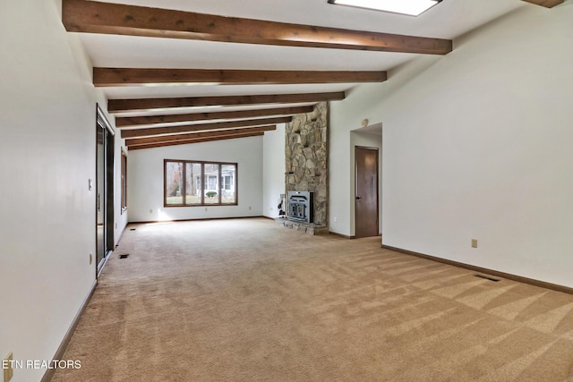 unfurnished living room featuring vaulted ceiling with beams, visible vents, light carpet, a stone fireplace, and baseboards