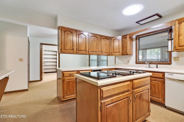 kitchen featuring brown cabinetry, dishwasher, a center island, black electric cooktop, and light countertops