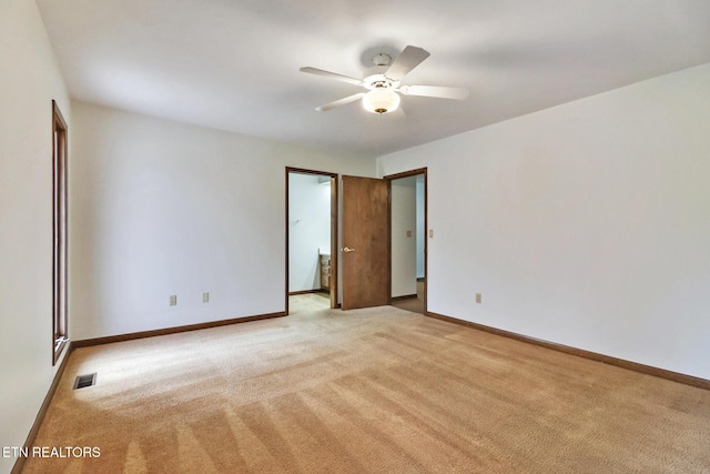 unfurnished room featuring light colored carpet, visible vents, ceiling fan, and baseboards