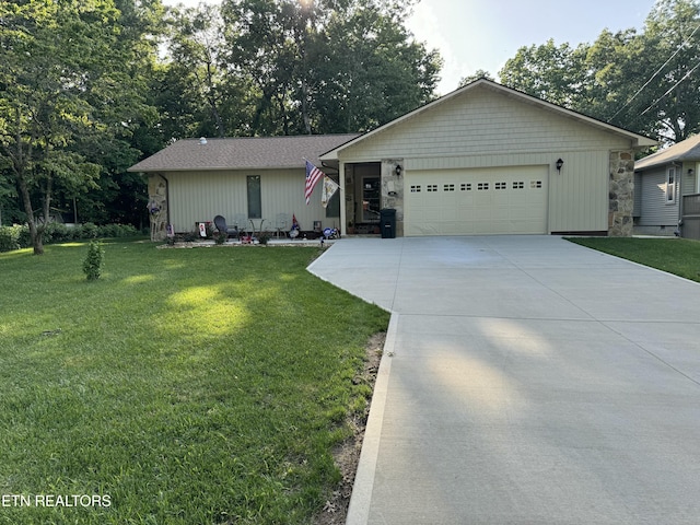 ranch-style home featuring a garage, stone siding, a front lawn, and concrete driveway