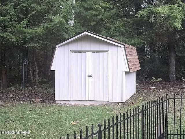 view of shed featuring fence