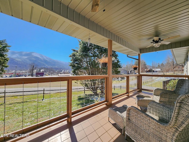 exterior space with a mountain view and ceiling fan