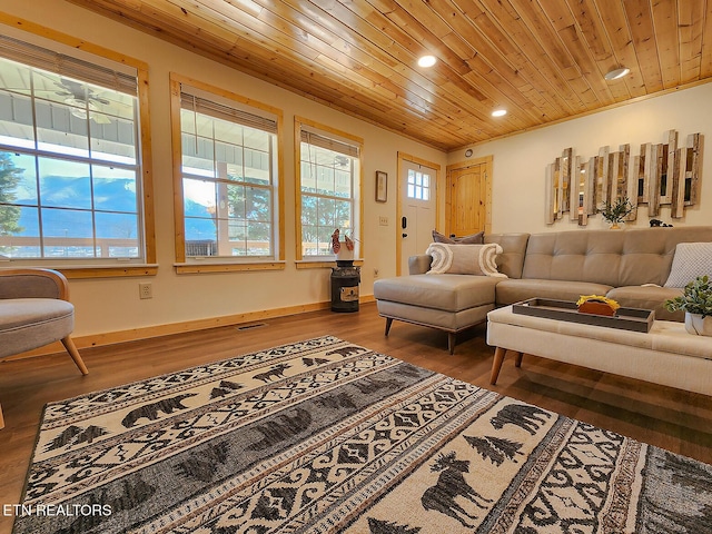 living area featuring visible vents, wood finished floors, baseboards, and wooden ceiling