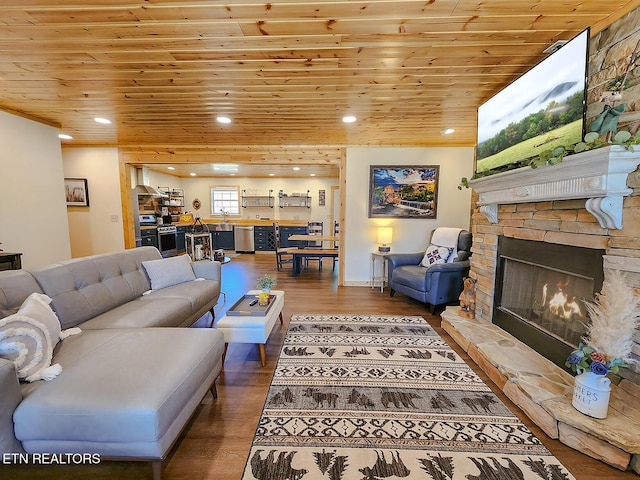 living area with a fireplace, wood finished floors, recessed lighting, and wood ceiling
