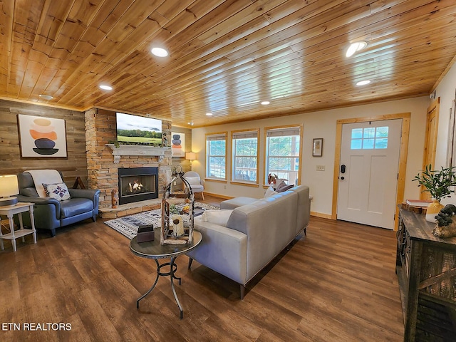 living area featuring dark wood-style floors, wooden walls, a fireplace, and wood ceiling