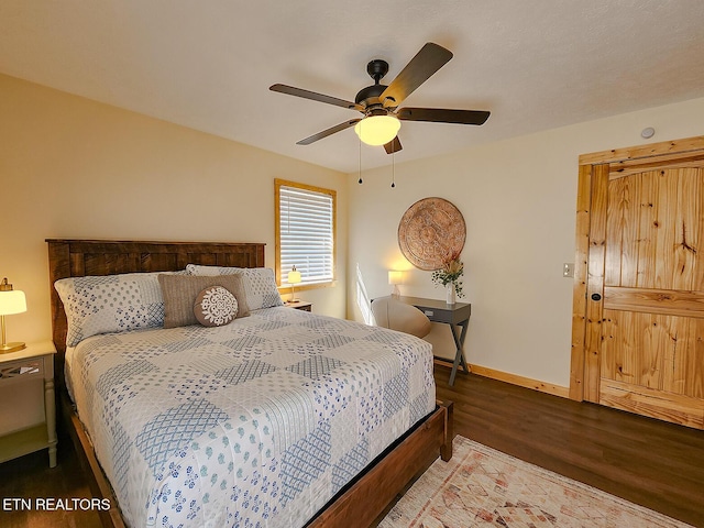 bedroom featuring ceiling fan, baseboards, and wood finished floors
