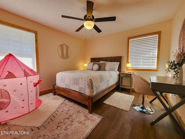 bedroom featuring ceiling fan, baseboards, and wood finished floors