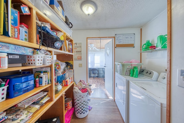 laundry area with separate washer and dryer and a textured ceiling