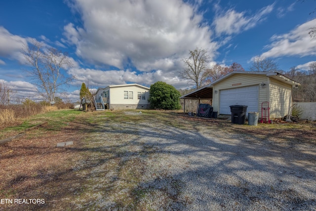 view of home's exterior with a garage and an outdoor structure