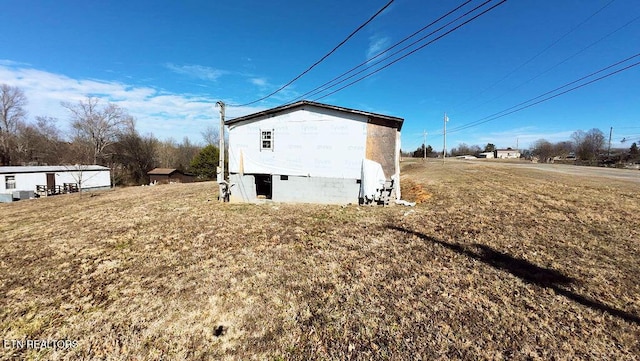 view of home's exterior with a yard