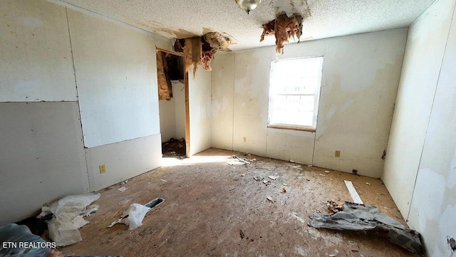 spare room with a textured ceiling