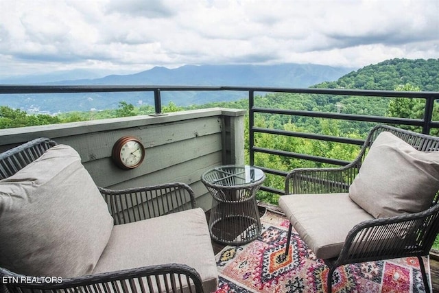 balcony with a mountain view and a view of trees