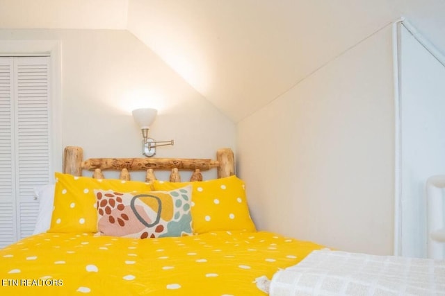 bedroom featuring a closet and lofted ceiling
