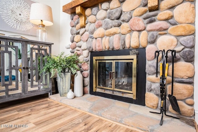 interior space featuring wood finished floors and a stone fireplace